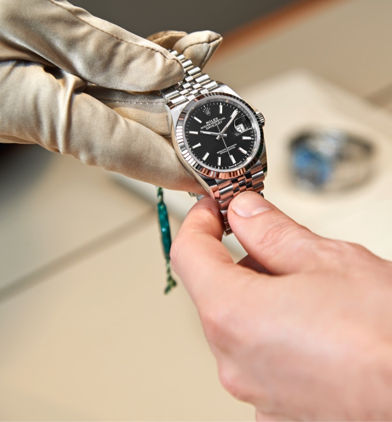 A Rolex watch being handed back to the owner