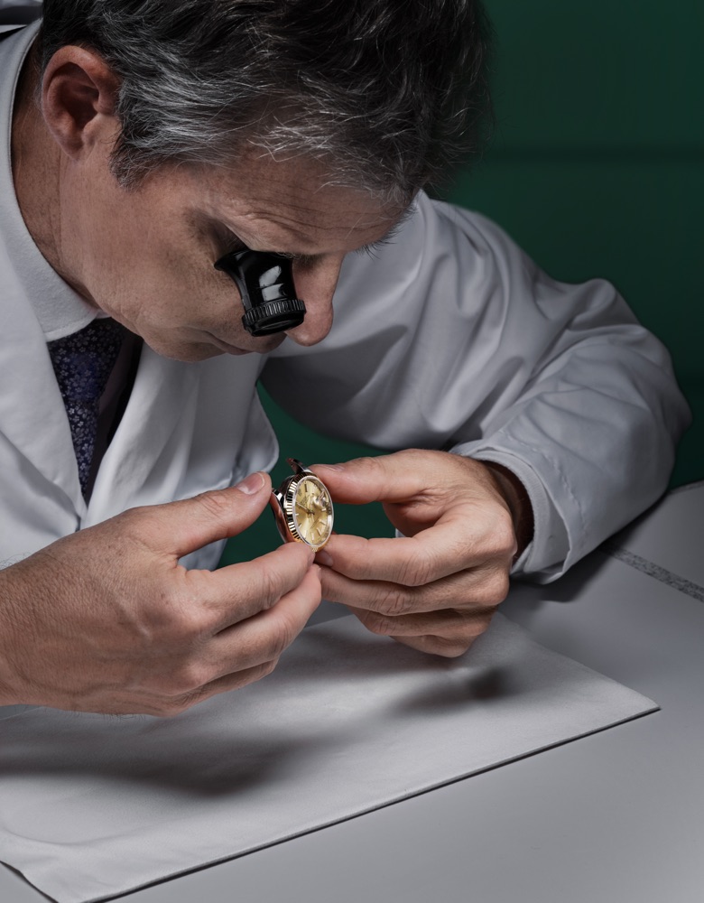 Man looking at a watch being serviced