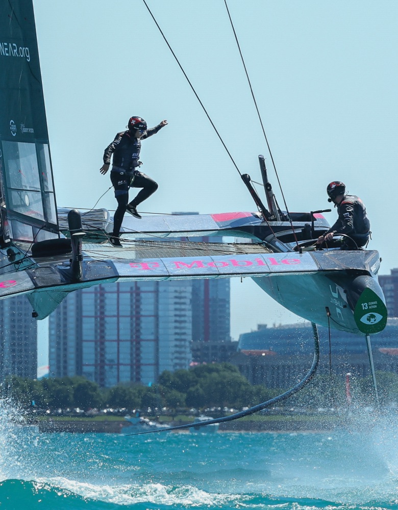 A foil with the team high above the water